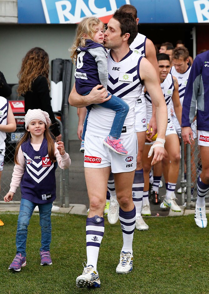 AFL 2015 Rd 15 - Hawthorn v Fremantle LAUNCESTON, AUSTRALIA - JULY 12: Luke McPharlin of the Dockers runs onto the field for his 250th match with his children during the 2015 AFL round 15 match between the Hawthorn Hawks and the Fremantle Dockers at Aurora Stadium, Launceston, Australia on July 12, 2015. (Photo by Michael Willson/AFL Media)